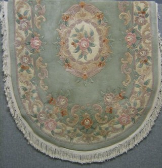 A turquoise and floral patterned oval Chinese rug 74" x 50"