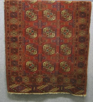A red ground Bokhara rug with 11 octagons to the centre 54" x 44"