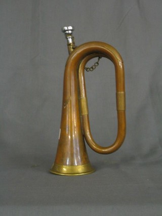 A brass and copper bugle marked B & H 400