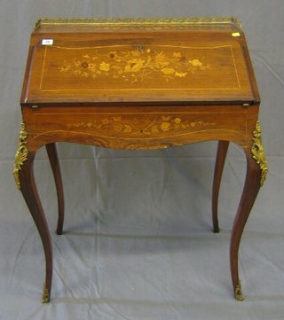 A 19th/20th Century inlaid Kingwood bonheur du jour with pierced brass three-quarter gallery, raised on cabriole supports, the fall front revealing a well and fitted interior 28"