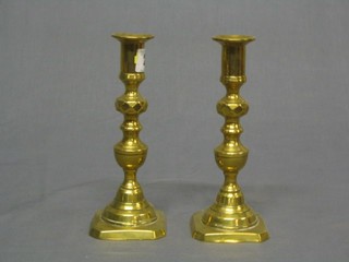 A pair of brass candlesticks with knopped stems and ejectors 7"