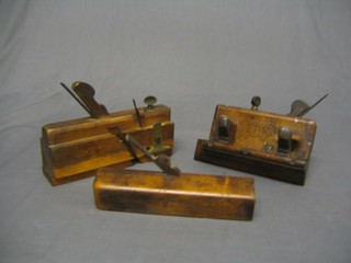 A wooden and brass mounted plough plane marked Ken Woodland and H W Hawkins together with 2 other planes (3)