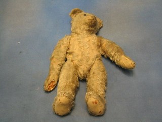 A 19th Century brown teddybear with snout nose, articulated limbs, 16" (worn - requires love)