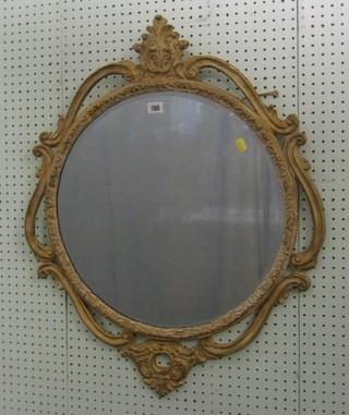 A circular plate wall mirror contained in a decorative frame 24" 10-20