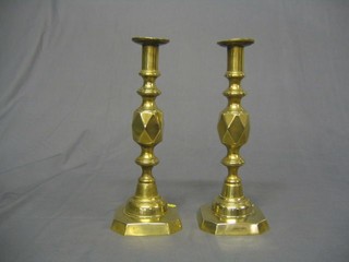 A pair of 19th Century brass candlesticks with knopped stems and ejectors 12" and a brass spiral turned candlestick (3)