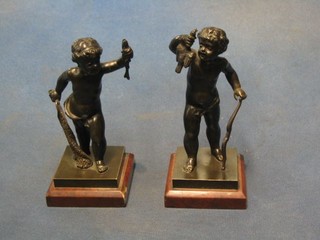 A pair of 19th Century bronze figures of standing  hunting Puti with fish and bird, raised on square marble bases 6"