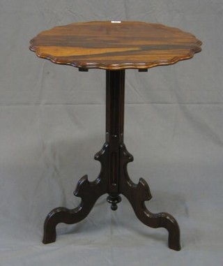 A 19th Century Continental Victorian rosewood circular snap top wine table with pie crust edge, raised on a chamfered column and tripod supports 21"