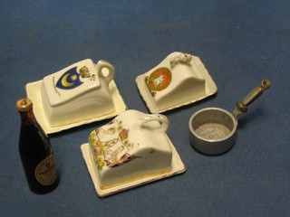 A miniature aluminium saucepan, a miniature bottle of Guiness and 3 miniature cheese dishes and covers