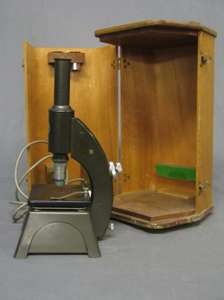 An electric microscope together with 2 boxes of slides