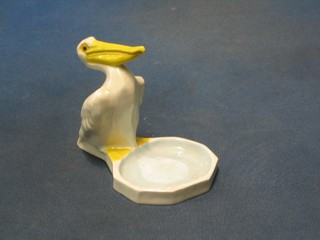 A Royal Worcester figure of a Pelican by a bowl, base marked Modelled by Stella R Crofts, with purple Royal Worcester mark and 2893 (slight chip to pelican's tail"
