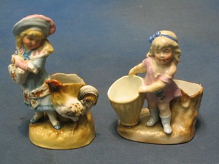 A pair of 19th Century German porcelain match strikers in the form of standing children 5"