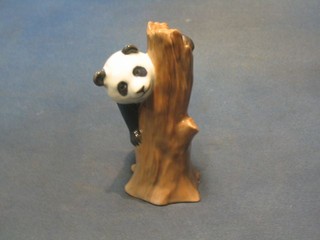 A Royal Copenhagen porcelain figure of a panda climbing a tree, base marked 664, 5"