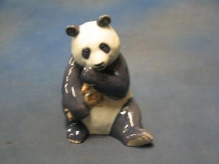 A Royal Copenhagen porcelain figure of a seated panda eating sugar cane, base marked Royal Copenhagen 662 7"