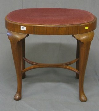 A walnutwood oval Queen Anne style stool with X framed stretcher, on cabriole supports 24"