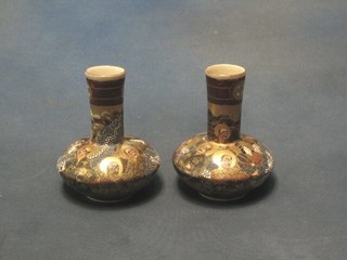 A pair of 19th Century Japanese Satsuma porcelain bottle vases, decorated court figures, the base with seal mark 5"