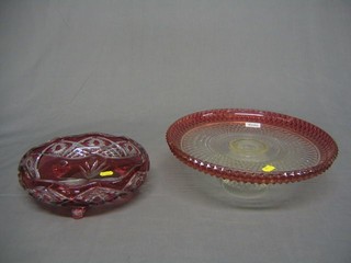 A cranberry glass jug with clear glass handle 8", a circular moulded comport, a cover overlay glass bowl 9", a globular shaped cut and overlay glass vase 5" and other items of coloured glassware