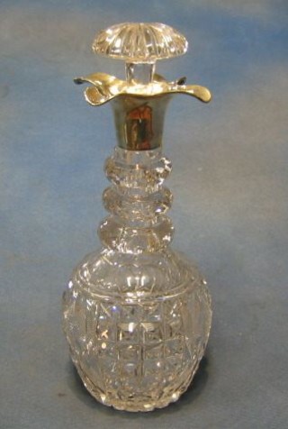 A cut glass ring neck decanter with silver collar