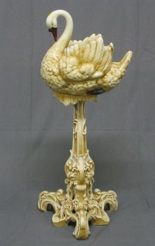 A pottery jardiniere in the form of a swan raised on a pierced Rococo style support 35"