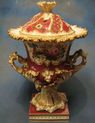A handsome 19th Century German porcelain twin handled pot pouri of campanular form, with deep red ground, floral panels and rococo handles, raised on a square base (f and r) 20"