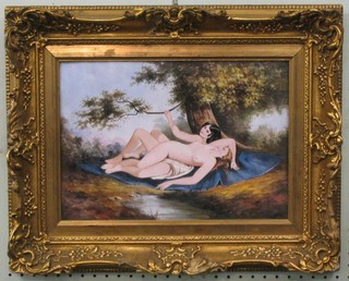 An enamelled plaque of 2 reclining ladies, 10" x 13" in a decorative gilt frame