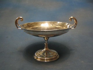 A silver twin handled bowl raised on a circular spreading foot, Sheffield 1907 by Walker & Hall, 14 os