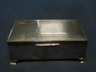 A silver cigarette box with engine turned decoration and hinged lid, Birmingham 1955, 7"