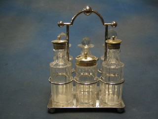 A cut glass and silver plated 4 bottle cruet frame with 4 bottles