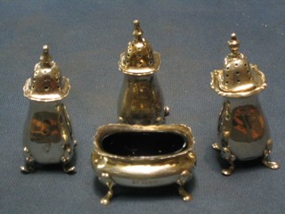 A 3 piece silver condiment set comprising 2 pepper pots, salts with blue glass liner, Chester 1908 and 1910, together with a silver pepper Birmingham 1921