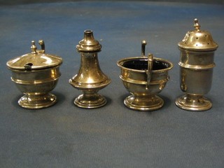 A silver 2 piece matched condiment set with circular mustard pot and pepper, Birmingham 1950 and 1951, together with a silver salt and a miniature silver twin handled trophy cup