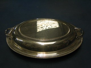 An oval silver plated twin handled entree dish and cover