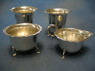 2 1930's circular silver plated vases with wavy borders and a matching cream jug and sugar bowl