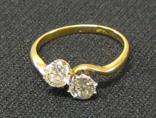 A lady's 18ct gold cross over dress ring set 2 large diamonds