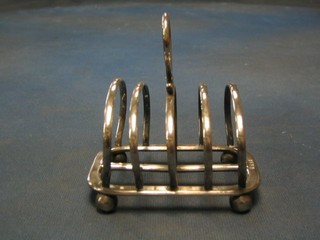 A silver 5 bar toast rack, raised on bun feet, Sheffield 1910 6 ozs
