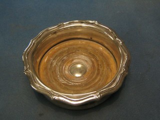 A circular silver plated wine coaster 6"