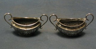 A pair of Edwardian twin handled boat shaped salts, Birmingham 1903 (no liners)