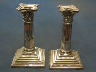 A pair of Victorian silver stepped and reeded Corinthian column candlesticks with detachable sconces, Sheffield 1899, 6"