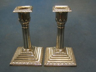 A pair of Victorian silver reeded candlesticks with stepped bases, acanthus capitals and detachable sconces, Sheffield 1896 6"