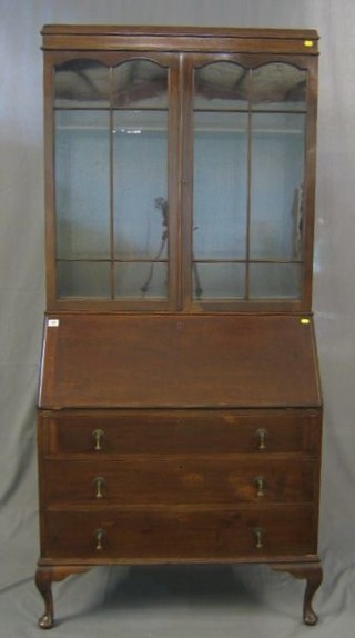 An Edwardian mahogany bureau bookcase, the upper section with moulded cornice, the shelved interior enclosed by an astragal glazed panelled door, the fall front above 3 long drawers, raised on bracket feet 36"