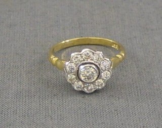 A lady's gold dress ring set a diamond surrounded by 10 diamonds (approx 0.75ct)