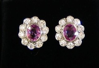 A pair of lady's pink sapphire ear studs surrounded by 10 diamonds (approx 1.43ct/0.82ct)