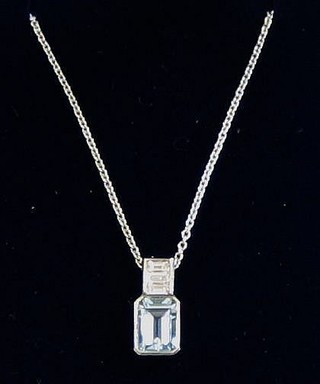 A lady's attractive pendant set an aquamarine surmounted by 4 baguette cut diamonds
