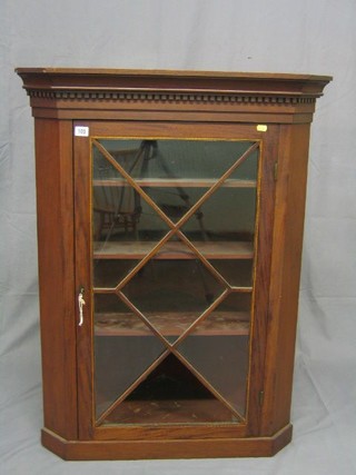 An 18th Century mahogany hanging corner cabinet with moulded and dentil cornice, the interior fitted adjustable shelves enclosed by astragal glazed panelled doors 31"