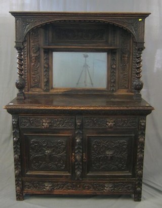 A Victorian carved oak sideboard with raised back supported by a pair of Ionic capitals with spiral turned columns, the base fitted 2 drawers above a double cupboard 54"