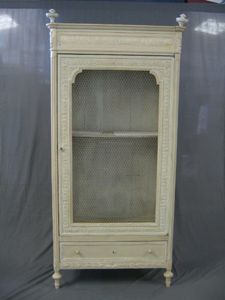 A 19th Century white painted French food cabinet, the interior fitted adjustable shelves enclosed by a grilled door, the base fitted drawer, raised on turned supports 39"