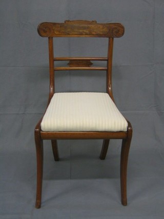 A set of 4 19th Century mahogany bar back dining chairs with shaped mid rails upholstered drop in seats, on sabre supports