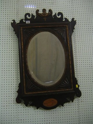 A Victorian oval bevelled plate wall mirror contained in a Chippendale style mahogany frame 34"