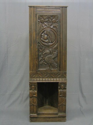 A 19th Century carved oak double corner cabinet, the upper section with carved panel decorated a head marked Noah, the base with recess 20"