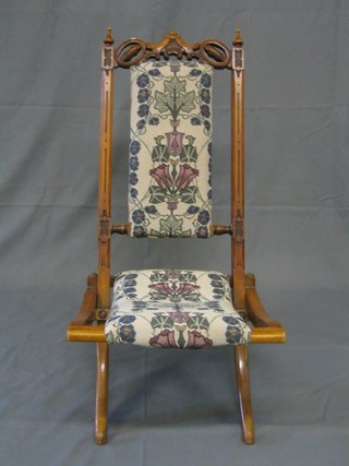 A 19th Century pierced and carved walnutwood folding campaign chair