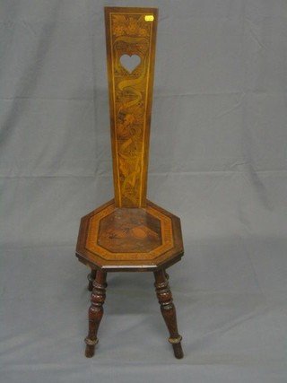A 19th Century inlaid walnutwood spinning chair, the back decorated musical trophies, the seat marked Music That Gentlier on the Spirit Lies Than Tired Eyelids Upon Tired Eyes