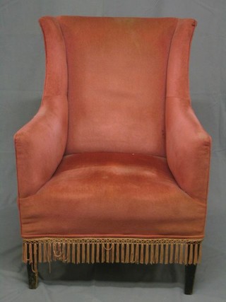 A pair of Edwardian mahogany framed wing arm chairs upholstered pink Dralon